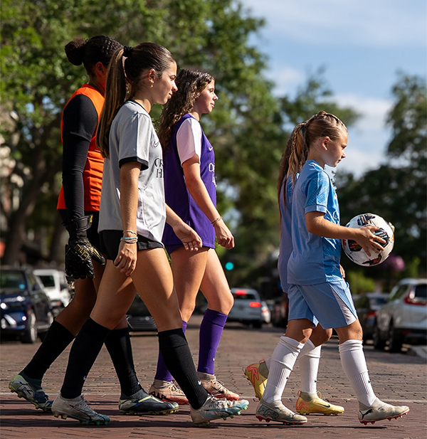 Youth Players Wearing Orlando Pride Soccer School Uniforms